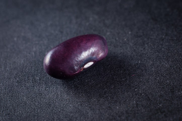 Shelling purple beans close-up. Macro shot of food.