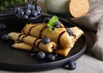 thin pancakes with blueberries for breakfast