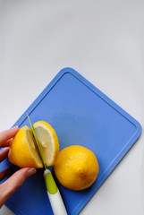 cut lemon on blue chopping Board