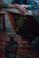 A woman looks like a sad little mermaid from a fairy tale