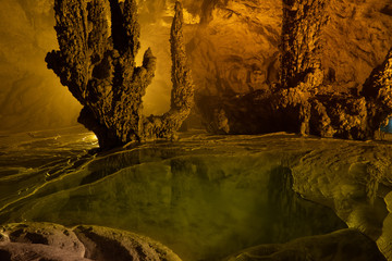 Nguom Ngao cave in North Vietnam, Cao Bang province. Enormous stalagmites and reflecting water...