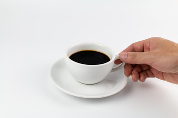 Cup of espresso coffee with hand on white background