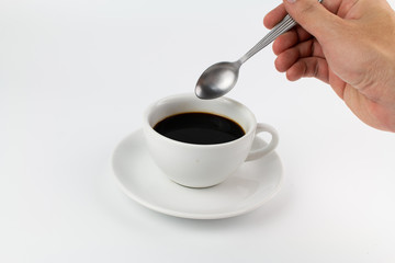Cup of espresso coffee with hand on white background