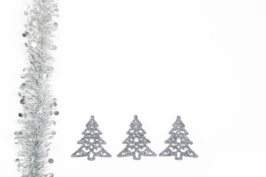 Christmas Silver Garland And Silver Trees Decoration On White Background.