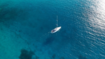 Aerial drone photo of luxury sail boat cruising in the deep blue Aegean sea, Greece