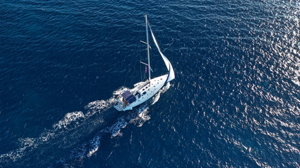 Aerial drone photo of luxury sail boat cruising in the deep blue Aegean sea, Greece