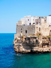 Polignano a mare coast in Bari, Italy during summer with turquoise blue water in the sea.