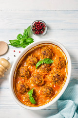 Oven baked meatballs on rustic wooden background. Top view, space for text.