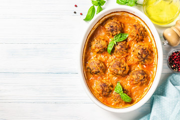 Homemade baked meatballs in tomato sauce. Top view, space for text.