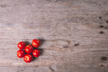 Naklejka na ściany i meble ripe tomatoes on wooden board in studio