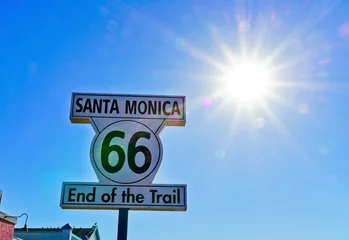 Fototapete Route 66 Road sign of route 66 as the terminus on Santa Monica beach on a sunny day.  © Javen