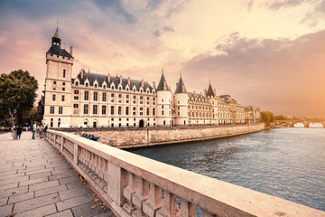 Naklejka premium City skyline with famous building Conciergerie which used to be a prison with a bridge over the river Seine in Paris