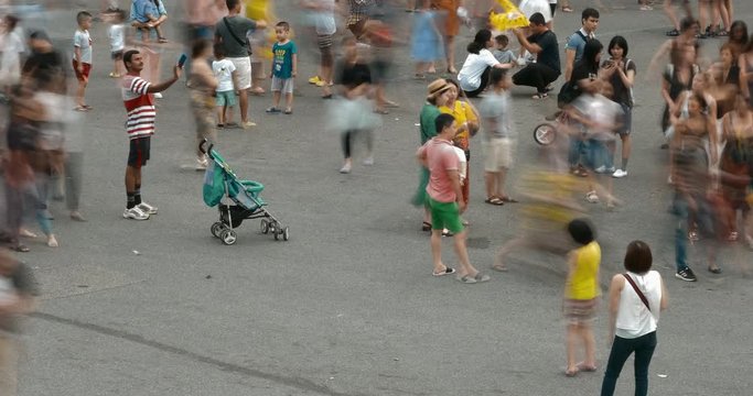 Hanoi, Vietnam 09 2019: 4k time lapse of crowd of anonymous people walking, playing on the playground in street city. High-quality free stock time lapse video footage view of crowd of people walking 