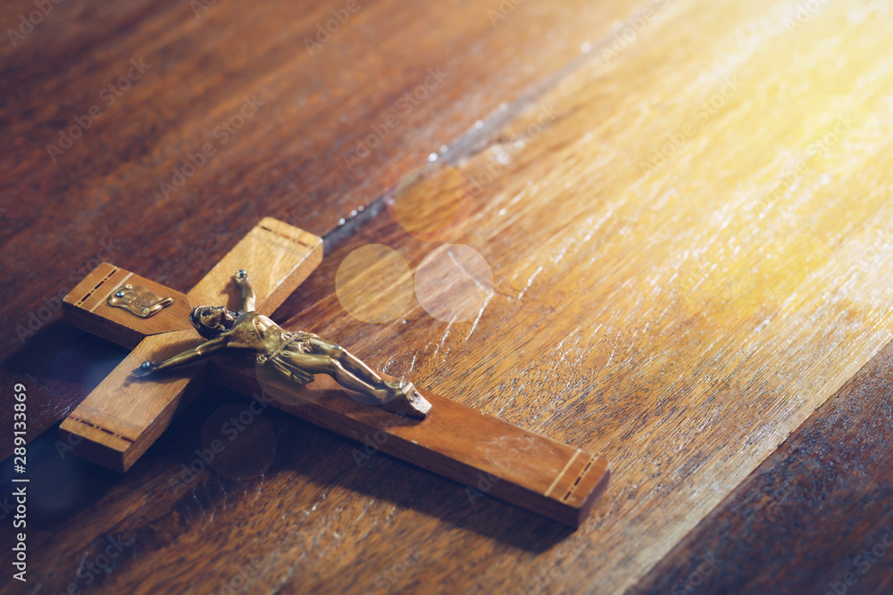 Poster Close up of Jesus's crucifix  on wooden table . Christian background trust and faith concept, copy space