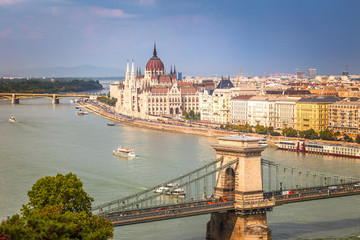 Fototapeta na wymiar Budapest, panoramic view of The Hungarian Parliament Building, historic buildings and the Chain Bridge over Danube river.