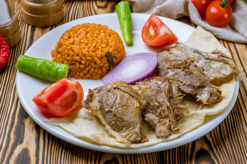 baked lamb with bulgur Turkish cuisine on wooden table