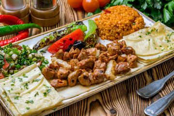 skewers of chop shish Turkish cuisine on wooden table