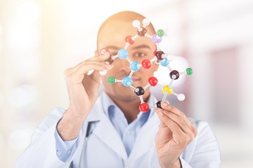 Hand holding syringe and vaccine.