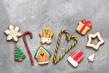 Christmas baking gingerbread and candy cane on a gray concrete background. Top view, flat lay, copy space.