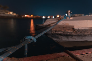 long time exposure of a boat in El gouna lagoon with a view of a hotel in the night and stars in the air.