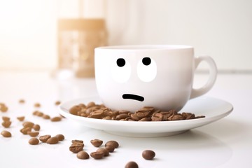 cup of coffee and beans on wooden background