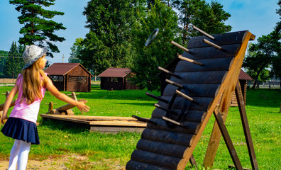 child 6-7 years old plays in the park