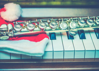 Close up of a flute on piano keys with Santa Claus. copy space  © isara