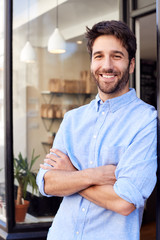 Portrait Of Male Owner Standing Outside Coffee Shop