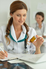 doctor sitting at desk at work in hospital