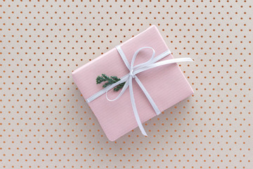Pink gift box with white ribbon top view background with copy space for your text. Flat lay.