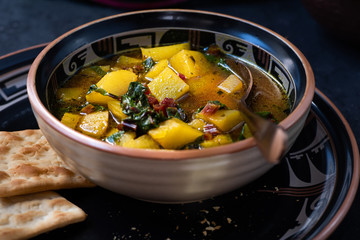 Potato and Beet Greens Soup on Dark Background