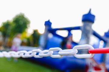 Naklejka premium Chain delimiting the playground of an inflatable castle