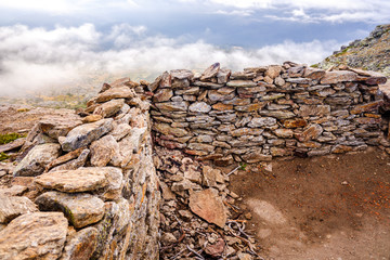 Stone shelter on top of the mountainous peak of Peñarala, in the Sierra de Guadarrama, Spain.