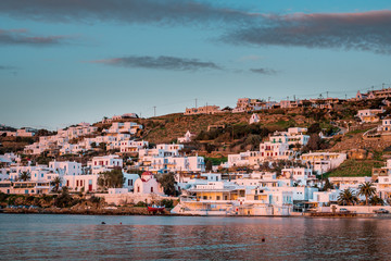 Chora Mykonos, Mykonos/ Greece - 01 22 2019 - Sunset on the famous Cycladic island with romantic evening mood by the sea and view from little venice with fishing boats and white villas for holidays
