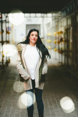 Mature woman with coat looking at camera in the city