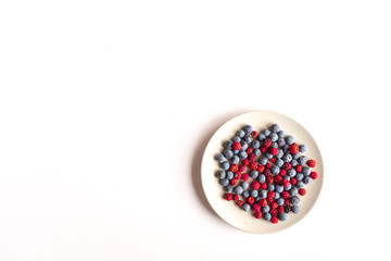 a plate with red berries and blackthorn