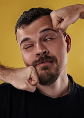 Fototapeta premium image of guy face receiving a punch against yellow background