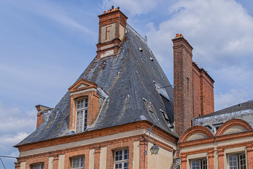 Fototapeta premium Beautiful Medieval (XII century) landmark – old royal hunting castle Fontainebleau. Fontainebleau Palace - one of largest royal chateaux in France (55 km from Paris). Architectural fragments of palace