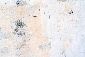 White and beige paint on the wall of a house. Construction and repair.