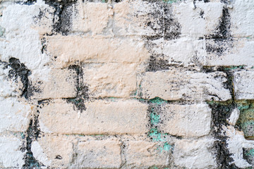 White and beige paint on the wall of a house. Construction and repair.