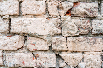 White and beige paint on the wall of a house. Construction and repair.