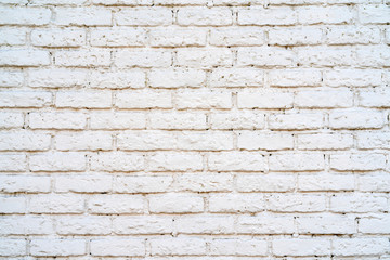 Brick wall is painted with white paint. Construction industry.