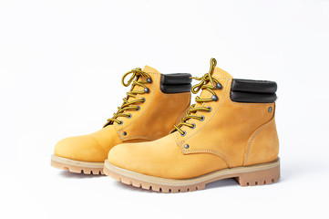Yellow men's work boots from natural nubuck leather isolated on white background. Trendy casual shoes, youth style. Concept of advertising autumn winter shoes, sale, shop
