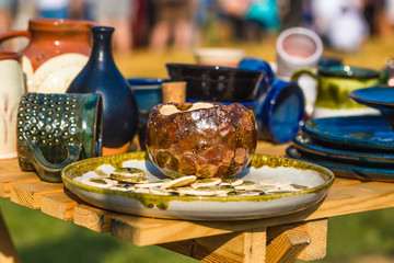 Ukrainian pottery. Pottery museum in Ukrainian village Oposhnya, center of Ukrainian pottery production. Different pottery products: bowls, pitchers, plates in museum.