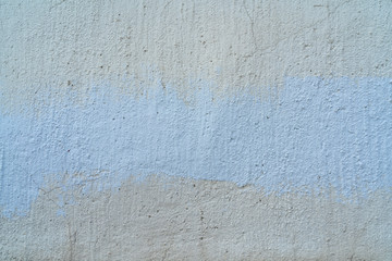 Fototapeta premium White and beige paint on the wall of a house. Construction and repair.