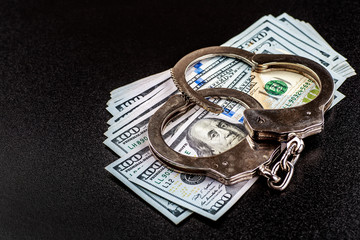 Police handcuffs. Financial crime, dirty money and corruption concept.Crime, Bribing, Fraud