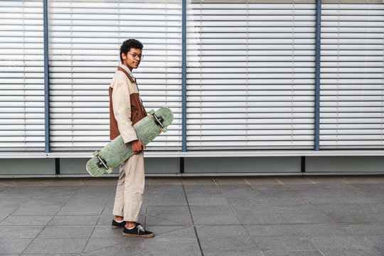 Skateboarder on background of window with rolettes