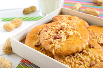 Shortbread dairy cookies with chopped nuts, milk and honey. Cookies in a box.  Close up