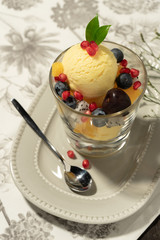 Top view  vanilla ice cream in glass blow topping by mixed fruits