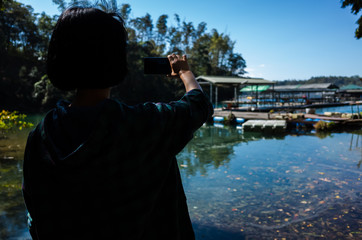Asian woman stand near the lake